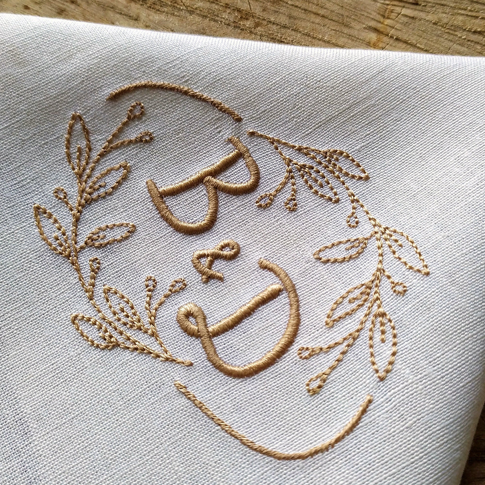 frame embroidery design stitched as a floral monogram wreath with B and D initials