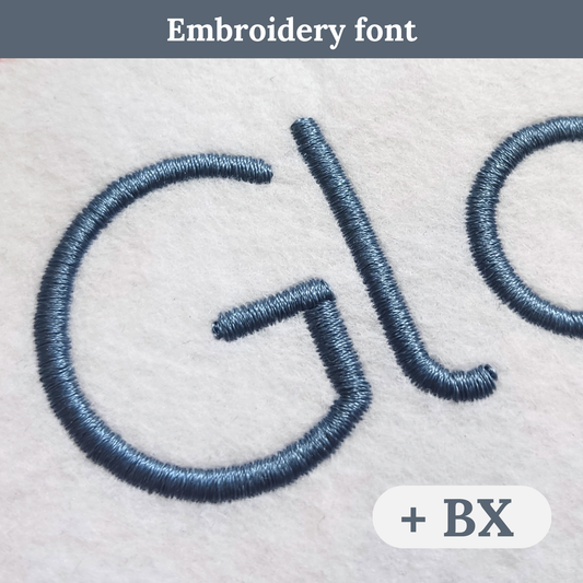 Close-up of embroidered lettering on a light fabric background, showing a dark blue-gray stitched font with text reading 'Embroidery font' at the top and a badge reading '+ BX' at the bottom right.